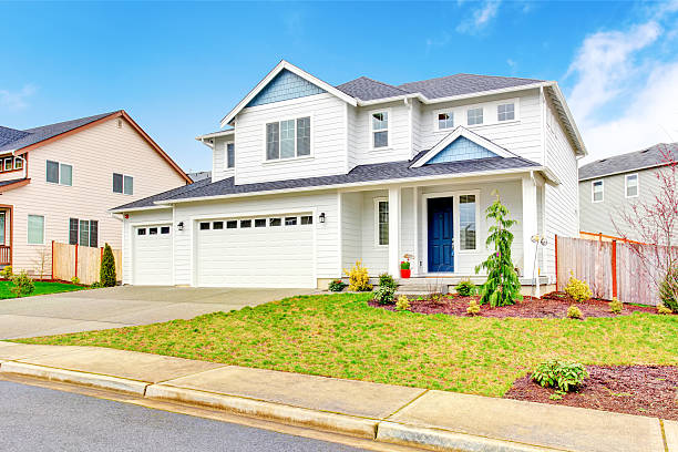 istock Luxury two level house exterior with garage and concrete driveway. 590166086