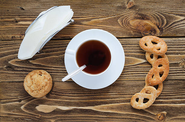 istock Cup of tea on a wooden table, top view 590166748