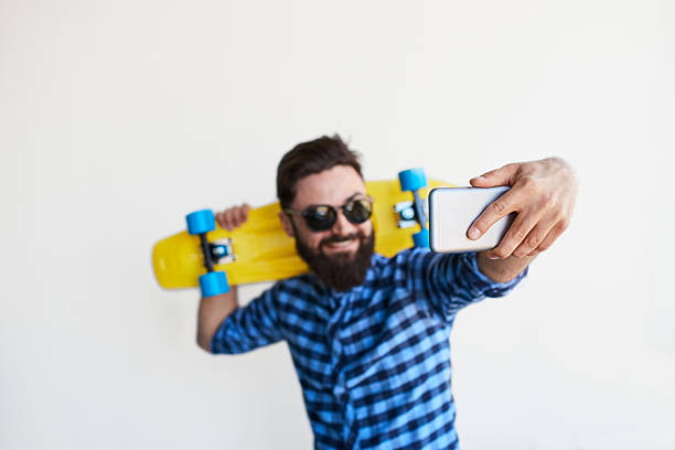 istock bearded hipster taking selfie with smartphone 590168548