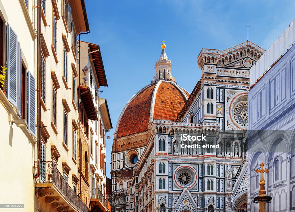 The Florence Cathedral at historic center of Florence, Italy The Cathedral of Saint Mary of the Flower (Florence Cathedral) at historic center of Florence, Tuscany, Italy. View from the Piazza San Giovanni. Dome on blue sky background. Florence - Italy Stock Photo