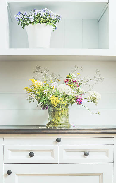 istock Flowers decoration on white dresser. 590168946