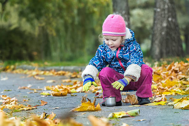 istock Two years old girl stretching hand to thermos flask cup 590169976