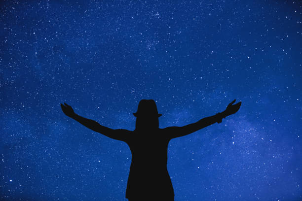 istock Girl enjoying under the night sky. 590170272