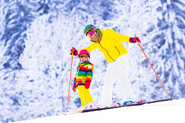 istock Mother and little girl learning to ski 590172110