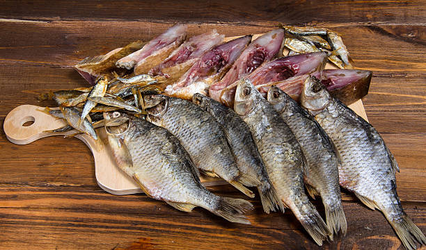 istock Dried fish on a wooden table 590173414