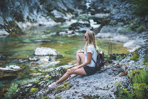 istock Girl near the mountain river 590173634