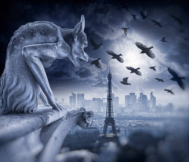 istock Gargoyle figur on Notre Dame with Eiffel Tower at night 590173750