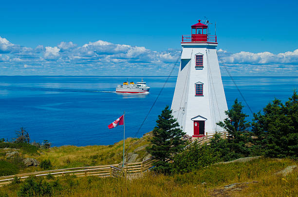 Lighthouse and ferry Swallowtail lighthouse with the ferry sailing by new brunswick canada photos stock pictures, royalty-free photos & images