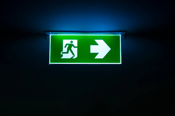 istock green emergency exit sign the way to escape 590176528