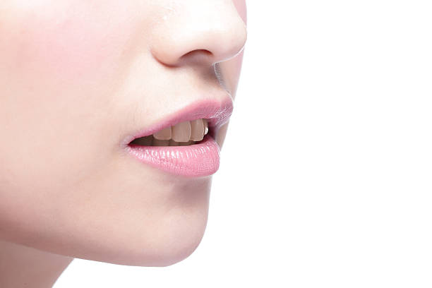 istock woman lips and yellow tooth 590176920