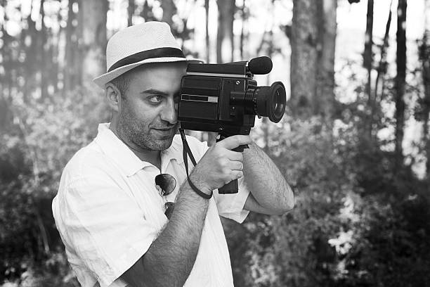 istock Young Man with Old Film Camera 590179830
