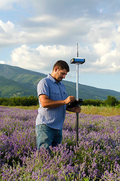istock Land surveyor working in the lavender field 590240340