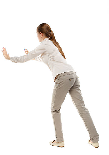 istock back view of woman pushes wall. 590240690