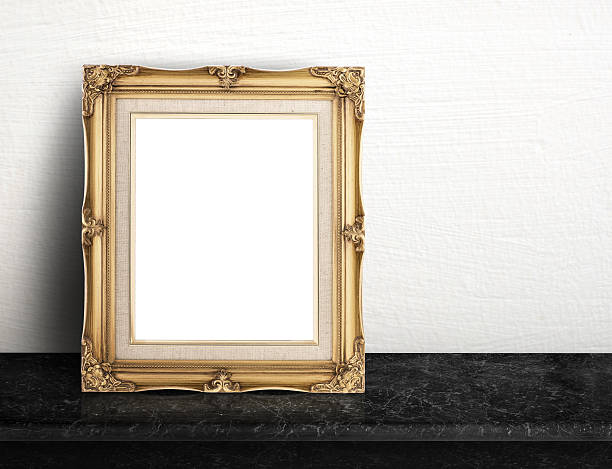istock Blank Gold victorian picture frame on black marble table 590241116