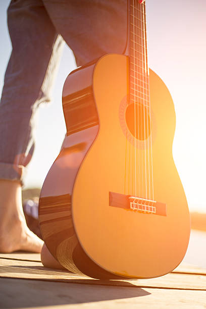 istock young woman on pier and  guitar 590241608