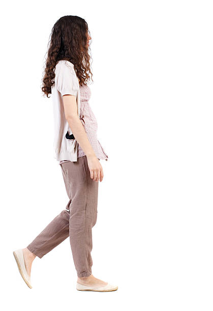 istock back view of walking  curly woman. 590242010