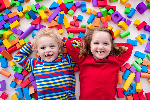 istock Happy little children playing with colorful blocks. 590243416