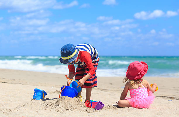 istock kids play with sand on summer beach 590243926