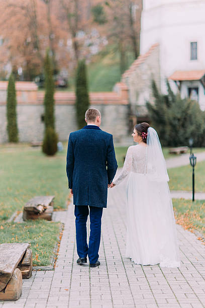 istock Charming newlywed couple at wedding day walking outdoors on beautiful 590247074