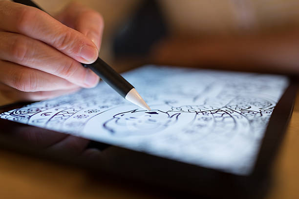 istock Female Hands Drawing Mandala on Electronic Tablet 590247758