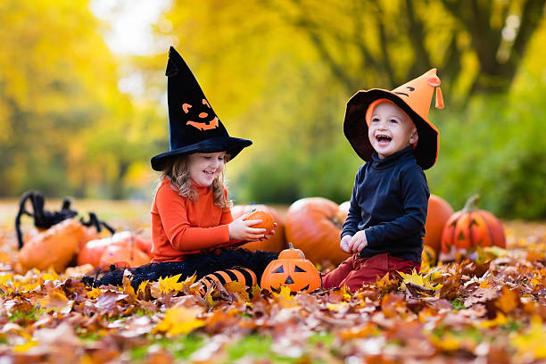 istock Kids carving pumpkins on Halloween 590248794