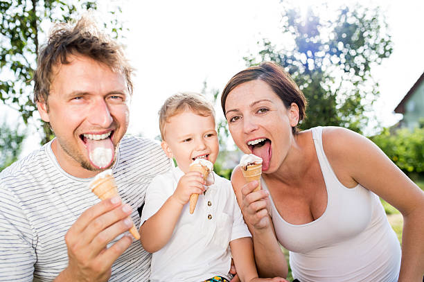 istock Father, mother and son eating ice cream, sunny summer 590249206