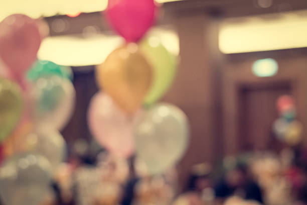 Blurred people in the banquet room with colorful balloon