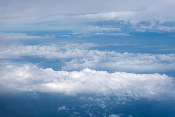 istock blue sky with clouds aerial view from airplane 590255666