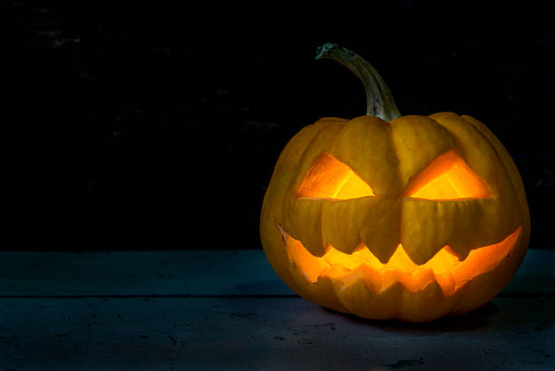 istock Halloween pumpkin head jack in dark night 590255710