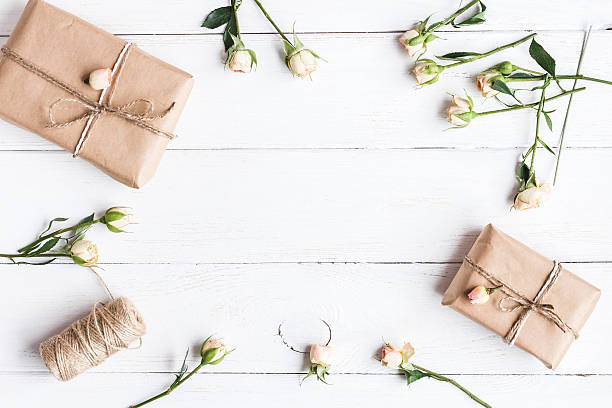 istock Gift and roses on wooden white background. Workspace. Flat lay 590257674