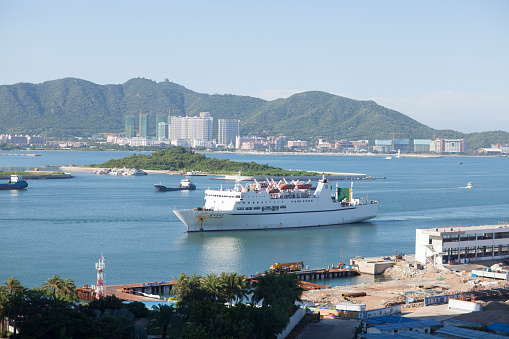 Sanya, Сhina - July 6, 2016: Cruise ship Beibu Wanzhi Xing (North Gulf Star) returning to Sanya from its weekly four-day cruise taking tourists around China's South China Sea assets