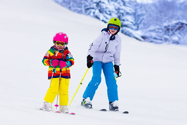 istock Kids skiing in the mountains 590261696