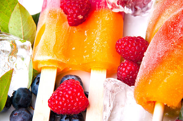 Composition of delicious ice cream, fruits and ice cubes