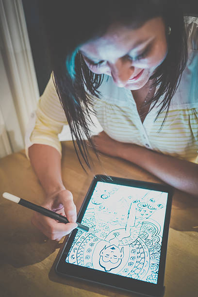 istock Female AdultDrawing Mandala on Electronic Tablet 590267892