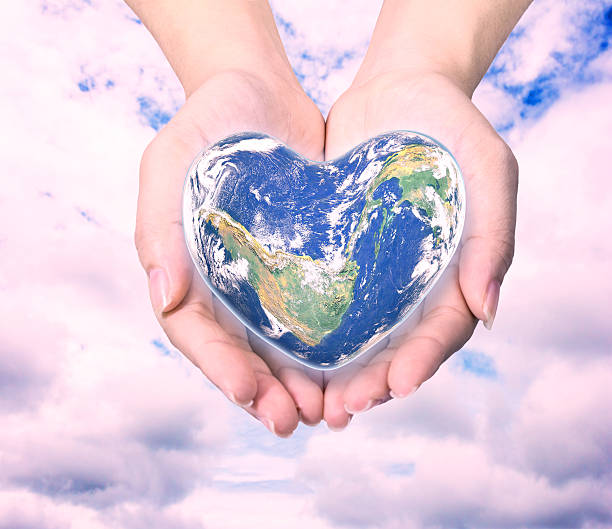 istock World in heart shape with over women human hands 590270534