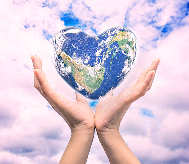 istock World in heart shape with over women human hands 590271314