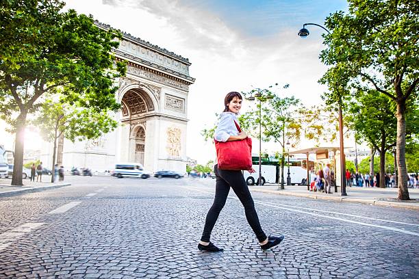 istock Woman walking in Paris, Arc de Triomphe surrounding area 590271508