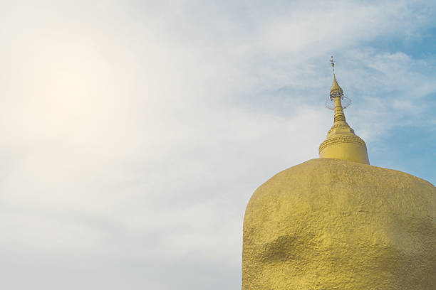 Thai Golden Buddhism rock in background blue sky