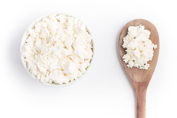Ricotta Cheese into a bowl Ricotta Cheese into a bowl over a wooden table ricotta photos stock pictures, royalty-free photos & images