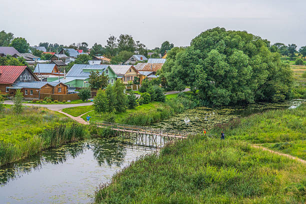istock Old wooden bridge though Kamenka river in Suzdal 590273376
