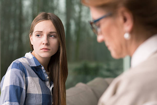 istock Thoughtful teenager and psychologist 590275986