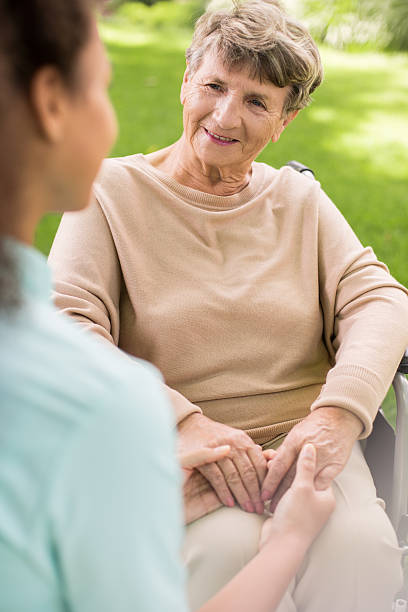 istock Ill woman with caregiver 590277684