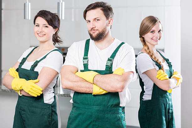 Cleaning team ready to clean the dirtiest room stock photo