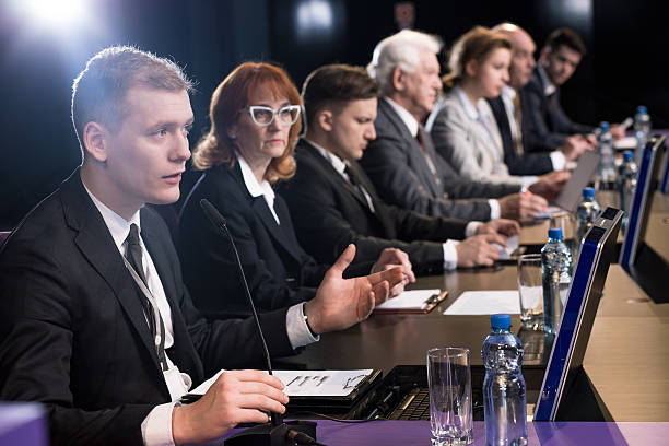 istock Politician debating at auditorium 590279394