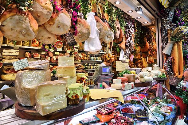 Florence market Florence, Italy - April 30, 2015: Vendor sells cheese at Mercato Centrale market in Florence, Italy. The market is an ultimate Italian shopping experience. It was opened in 1874. italian cheese stock pictures, royalty-free photos & images