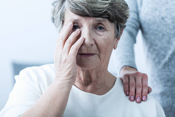 Woman suffering from senility Image of sad woman suffering from senility senior adult memory loss stock pictures, royalty-free photos & images