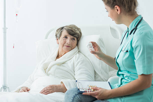 istock Nurse giving medcines to patient 590282324