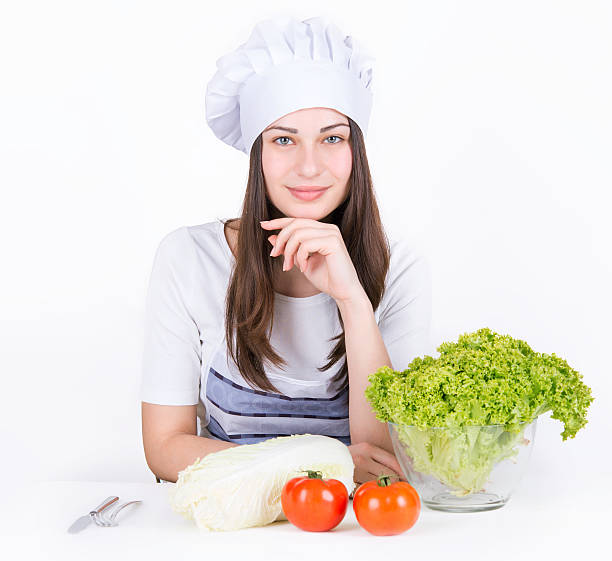istock girl chef at the salad and vegetables 590282764