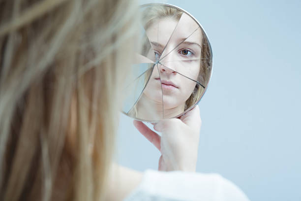 Woman with mental disorder Image of woman with mental disorder holding broken mirror bipolar disorder stock pictures, royalty-free photos & images