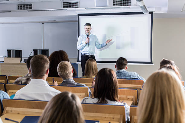 I'm sure you will find it interesting Image of a teacher giving a lecture to his students teacher projector stock pictures, royalty-free photos & images
